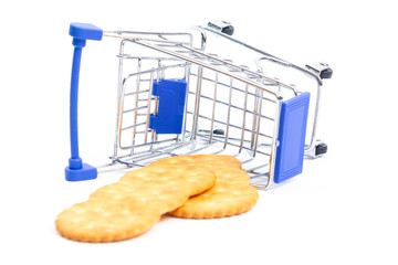 fallen shopping cart with crackers on a white background. isolate