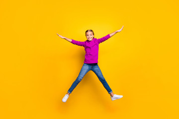 Fototapeta na wymiar Full length body size view of her she nice attractive lovely charming pretty cheerful cheery girl jumping having fun free time isolated on bright vivid shine vibrant yellow color background