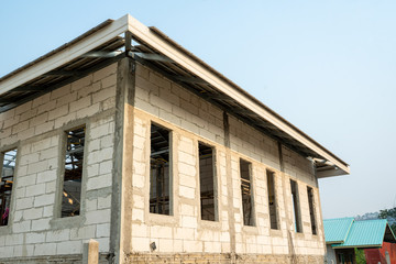 House under construction,Walls from lightweight aggregate concrete blocks with empty door frames,...