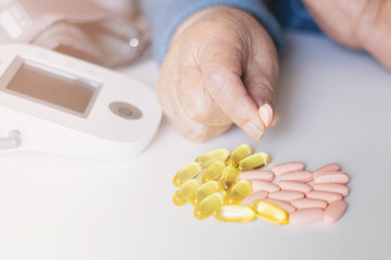 Elderly woman with pills hand, grandmother with medicines