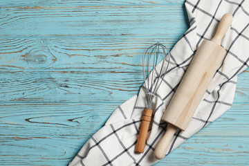 Rolling pin, whisk on a blue wooden background