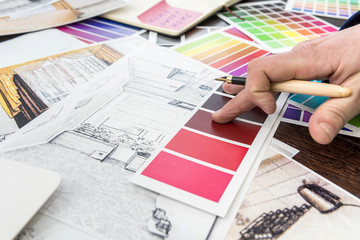Home designer work at office house sketch with color catalog for dream modern renovation apartment. Archtecture house plan and color sample