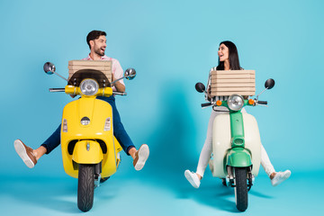 Full body photo of funny lady guy drive two vintage retro moped carry paper pizza boxes courier occupation look eyes good mood formalwear outfit isolated blue color background
