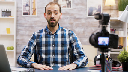 Excited influencer while recording for his vlog in living room