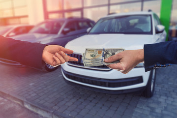 Buying a new car. The buyer and seller enter into an agreement to buy or lease a car