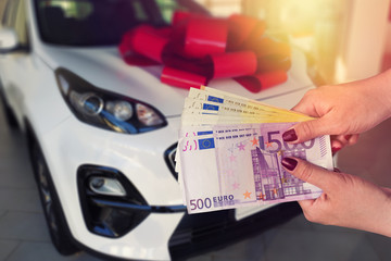 the customer pays euro banknotes for his dream - a new car
