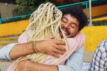 Happy person gives his friend a tight hug. Celebrations, reunions, meetings, friendship. Affection and union.