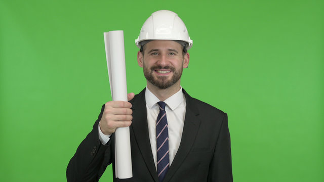 The Cheerful Engineer showing Construction Blueprint against Chroma Key