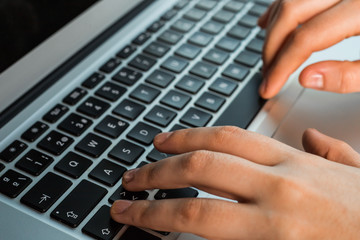 hands using the keyboard of a laptop