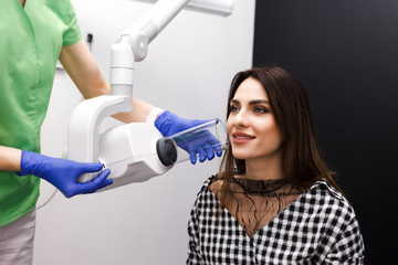 Dentist makes x-ray of the dental cavity for the patient in clinic