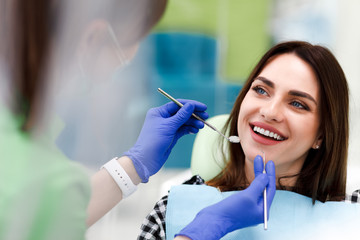 Smiling woman at the dentist's appointment. beautiful positive girl at a routine examination at the...
