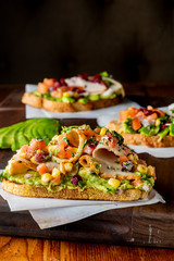 Avocado Toast. Fresh organic avocados mixed with olive oil lemon and salt and pepper paired with radishes micro greens and celery leaves. Spread on whole grain crispy toast. New American favorite.