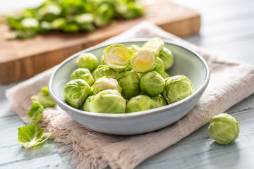 Fresh brusseles sprouts in bowl on kitchen table