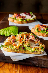 Avocado Toast. Fresh organic avocados mixed with olive oil lemon and salt and pepper paired with radishes micro greens and celery leaves. Spread on whole grain crispy toast. New American favorite.