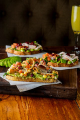 Avocado Toast. Fresh organic avocados mixed with olive oil lemon and salt and pepper paired with radishes micro greens and celery leaves. Spread on whole grain crispy toast. New American favorite.