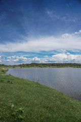 Beautiful spring river in the flowing nature. Colorful landscape in the morning and evening. Travel to deserted places of the world. Stock photo for design