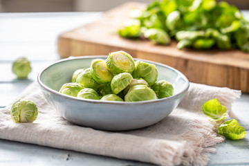 Fresh brusseles sprouts in bowl on kitchen table