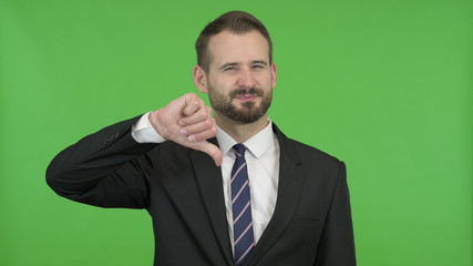 The Young Businessman Showing Thumbs Down against Chroma Key