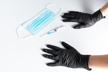 Hand in medical gloves holding syringe with vaccine