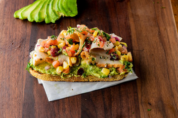 Avocado Toast. Fresh organic avocados mixed with olive oil lemon and salt and pepper paired with radishes micro greens and celery leaves. Spread on whole grain crispy toast. New American favorite.