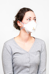 caucasian brunette woman in protective medical mask on face protection for spreading of disease virus SARS-CoV-2, Coronavirus, COVID-19. white background