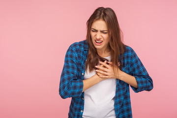 Infarction. Portrait of sick stressed worried woman in checkered shirt clutching chest suffering...