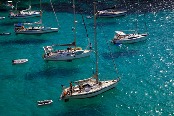 Obraz premium Macarella, Menorca / Spain - June 25, 2016: Boats at Cala Macarella bay, Menorca, Balearic Islands, Spain