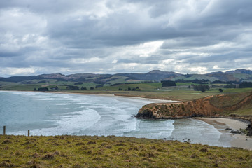 Fototapeta premium Stunning panorama of a cliff in Dunedin taken on a cloudy day, New Zealand