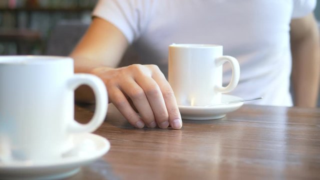 closeup. the man wears a wedding ring, sitting in a cafe.
