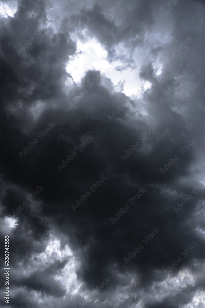 Poster terrible thunderclouds from the side of a plane. gloomy epic clouds. background image in a dark gray