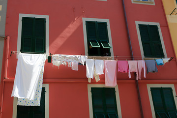 Riomaggiore ( SP ), Italy - April 15, 2017: Clothes drying on clothesline, Riomaggiore, gulf of Poets, Cinque Terre, La Spezia, Liguria, Italy
