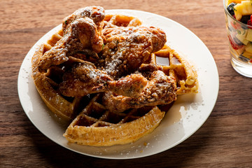 Chicken & waffles. Classic American Diner Style Breakfast or Brunch menu item favorite. Crispy homemade fried chicken on top of home buttermilk waffles topped with butter and maple syrup. 
