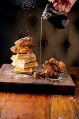 Chicken & waffles. Classic American Diner Style Breakfast or Brunch menu item favorite. Crispy homemade fried chicken on top of home buttermilk waffles topped with butter and maple syrup. 