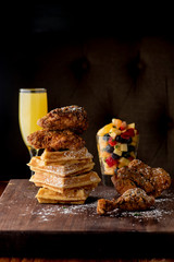 Chicken & waffles. Classic American Diner Style Breakfast or Brunch menu item favorite. Crispy homemade fried chicken on top of home buttermilk waffles topped with butter and maple syrup. 