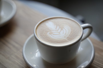 cup of coffee on wooden table