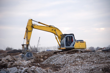 Excavator with jaw crusher bucket for crushes concrete and recycle material. Machine, capable of...