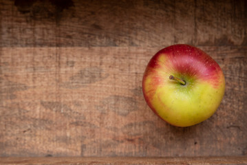 Garden green apples on a background of a wooden textured board.