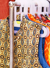 Closeup view of Indian woman fancy and fashion dress Hung on hangers in display of a retail shop       