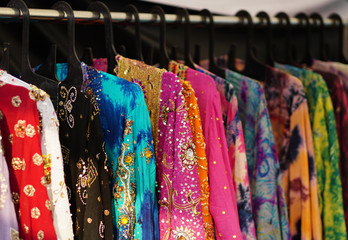  Closeup view of Indian woman fancy and fashion dress Hung on hangers in display of a retail shop                 