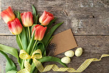Easter eggs and spring flowers on a wooden background.Image