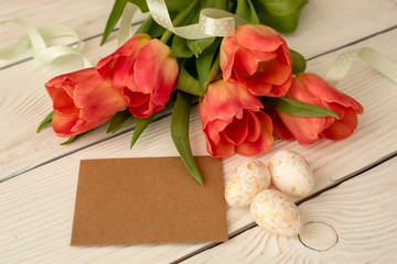 Easter eggs and spring flowers on a wooden background.Image