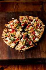 Pizza. Classic traditional Italian entrée favorite. New York Style Pizza with marinara sauce and topped with mozzarella cheese, meats and fresh vegetables. Baked in wood burning oven