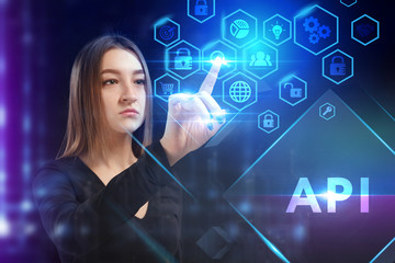 Business, Technology, Internet and network concept. Young businessman working on a virtual screen of the future and sees the inscription: API