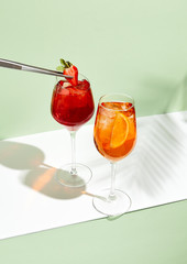 Red and orange summer cocktail on creative background