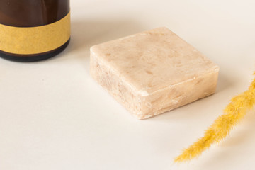 Handmade bar of soap, pumice stone and washcloth. Olive soap, facecloth and pumice stone on wooden board.