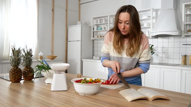 girl in the kitchen preparing according to the recipe