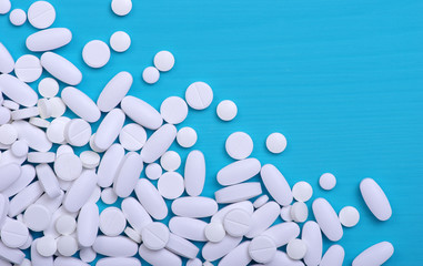 Heap of pills on blue