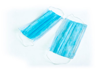 Blue medical surgical flu illness protective mask over isolated white background