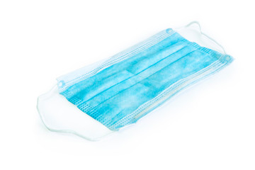Fototapeta premium Blue medical surgical flu illness protective mask over isolated white background