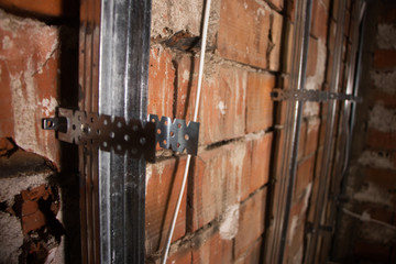 putting plasterboard on the wall preparation for insulation